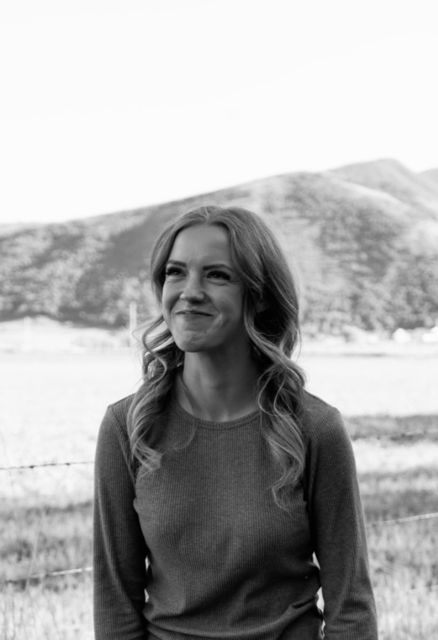 Leigh standing outdoors in front of snow-covered mountains